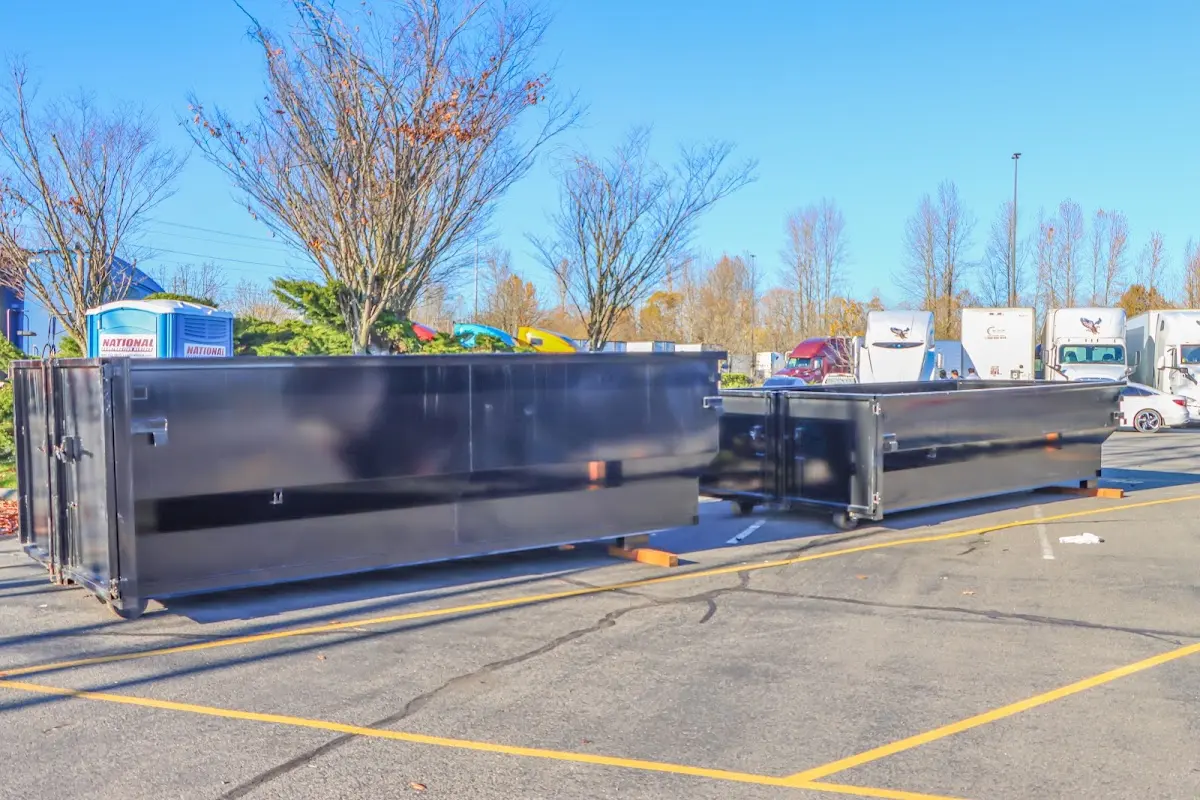 Professional dumpster rental service with roll-off container on residential driveway in Ocean Pointe